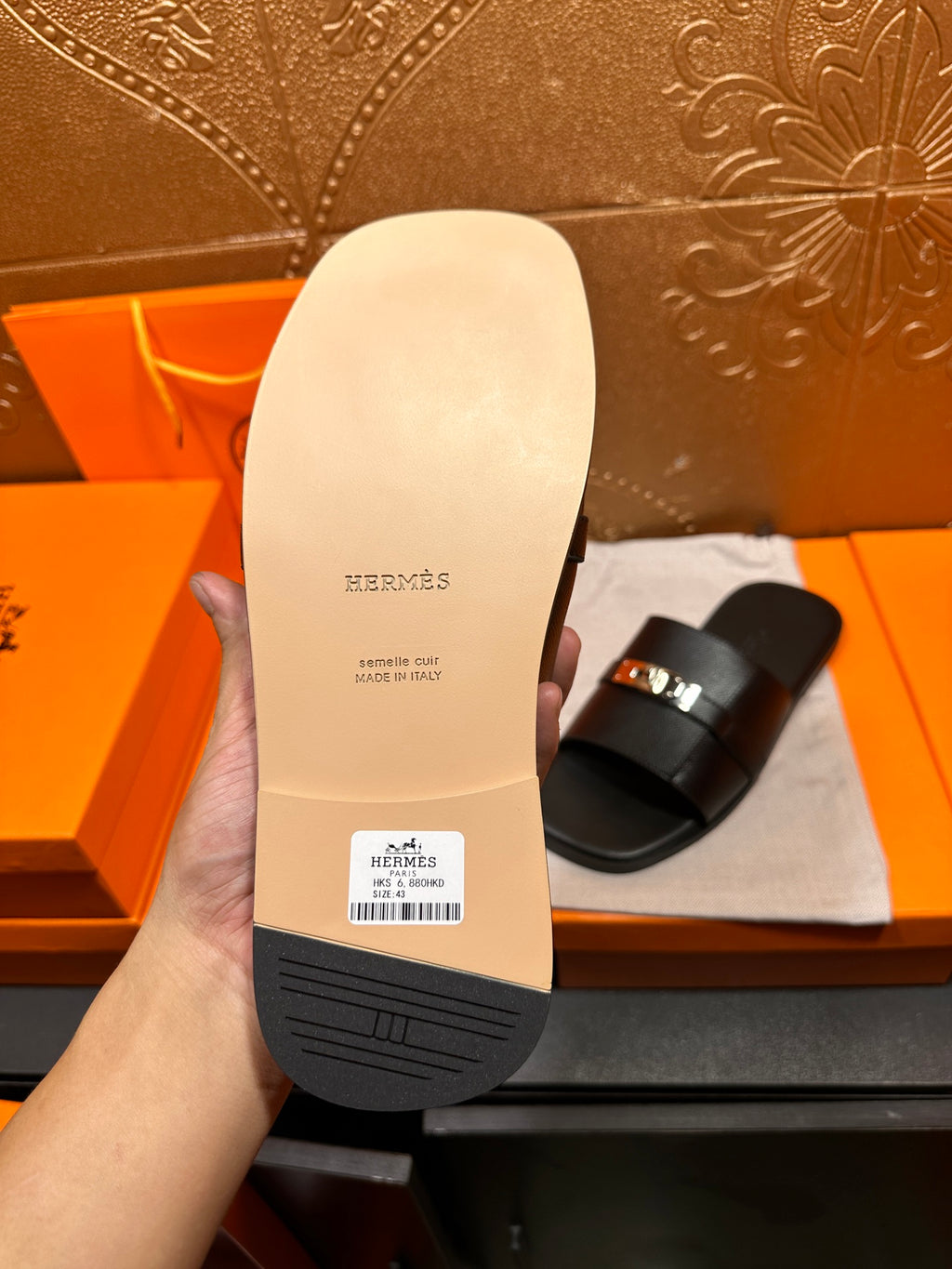 Hermes sandal outsole bottom view, textured sole with brand markings