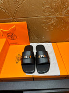 Hermes black leather slide sandals with square metal buckle, two wide straps