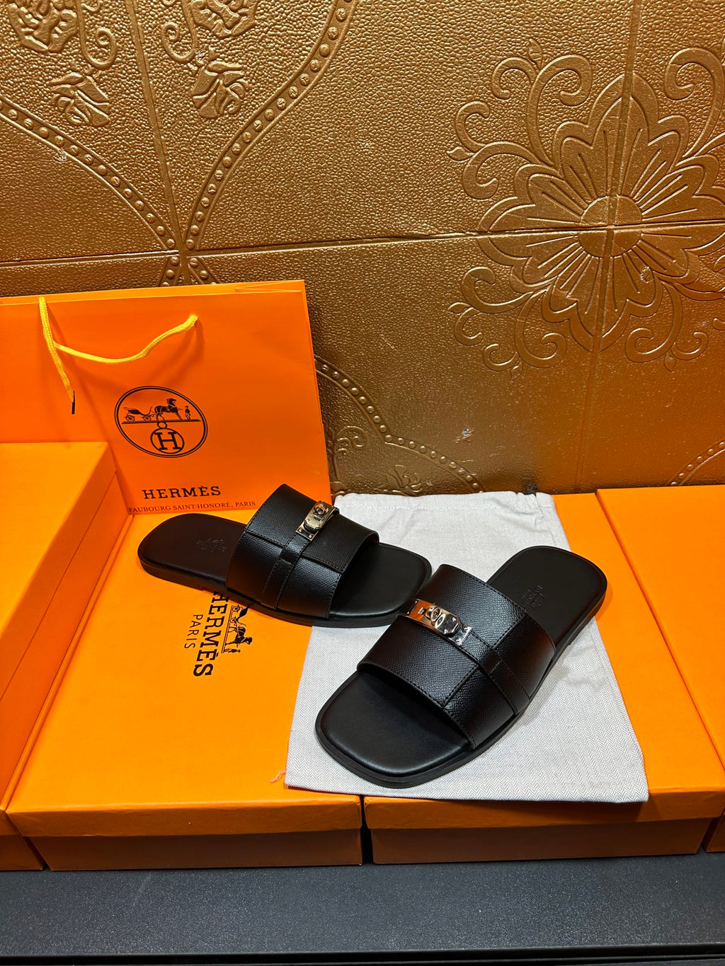 Hermes black leather slide sandals, side view with two strap overlays
