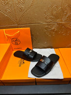 Hermes black leather slide sandals, side view with two strap overlays