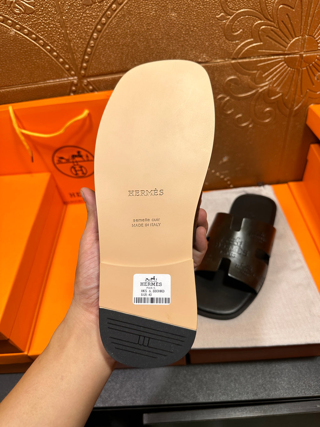 Hermes sandal sole in hand, cream outsole with HERMES logo