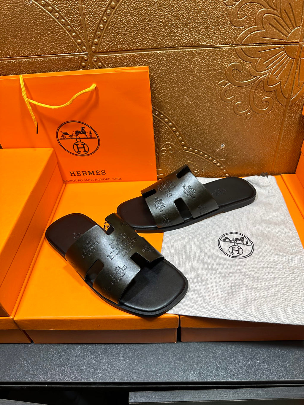 Hermes black leather slide sandals with embossed cross straps and open toe