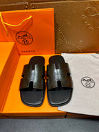 Hermes black leather sandals with embossed H straps and open toe