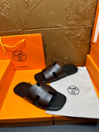Hermes sandals, black slide sandals with molded footbed and embossed strap details