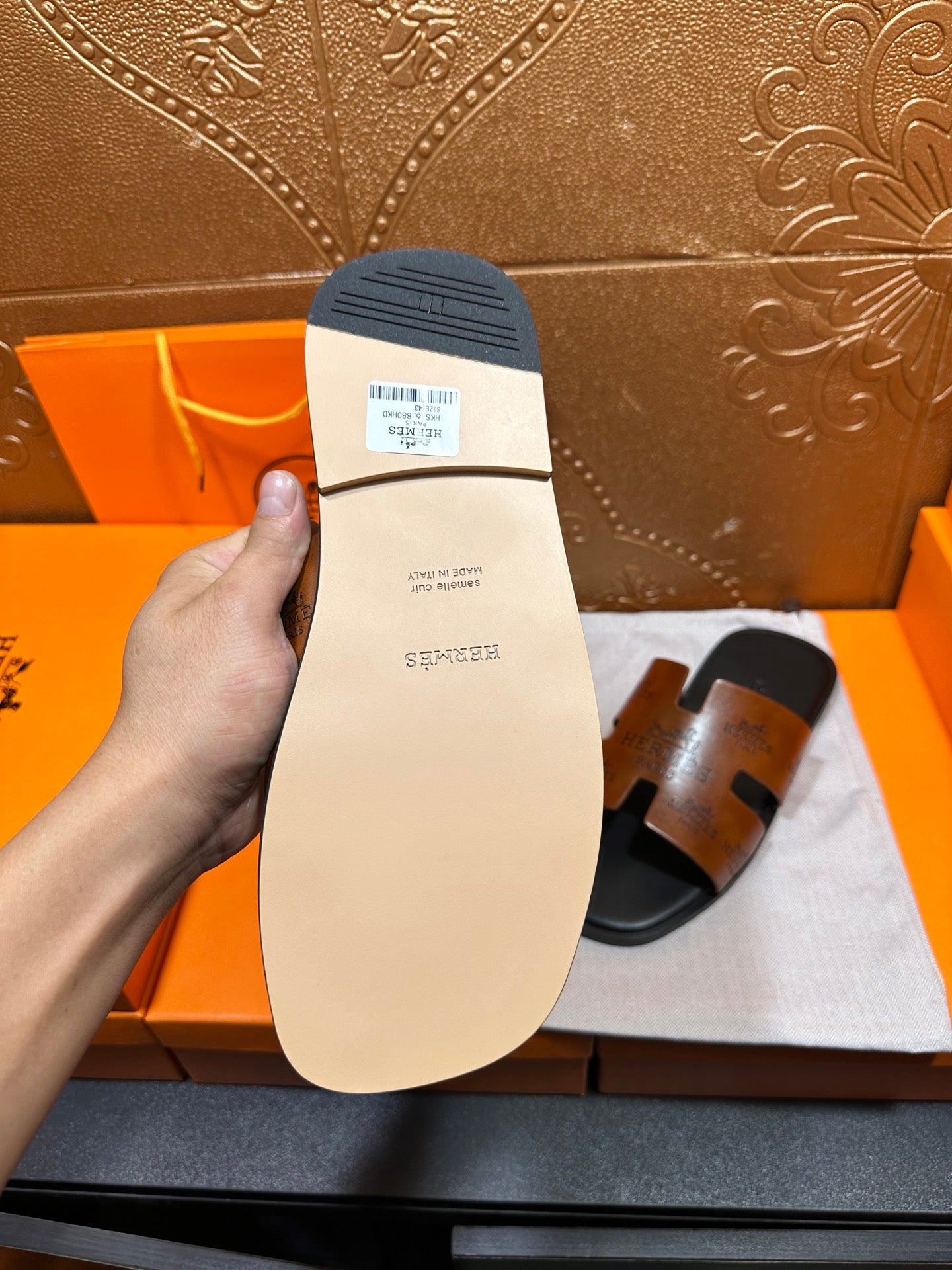Hermes slide sandal outsole, light beige rubber sole with size label.