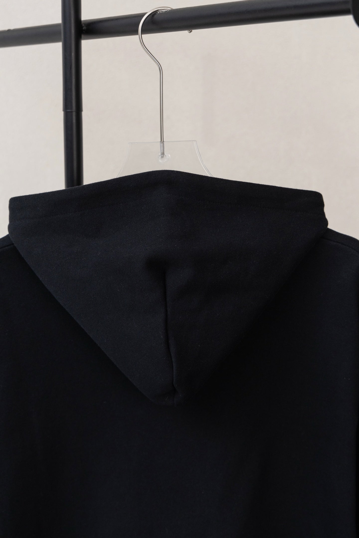 Dior black hoodie back view with centered hood and raised seam details