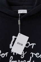 Dior black hoodie with 'Dior' hanging tag over the chest graphic