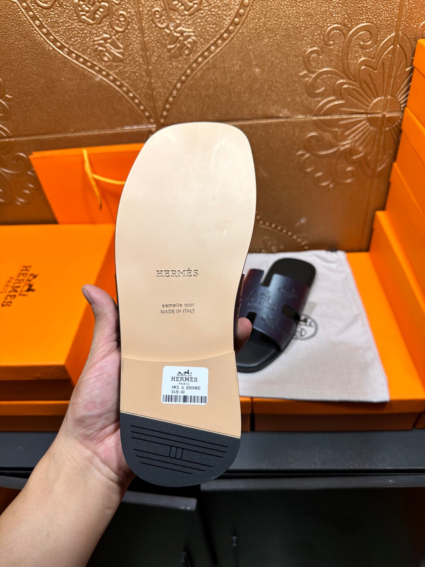 Hermes slide sandal outsole, white bottom with embossed Hermes text and barcode