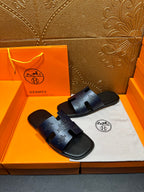 Hermes slide sandals in dark blue with embossed logo strap detail