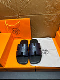 Hermes slide sandals in dark blue with embossed logo on wide front straps