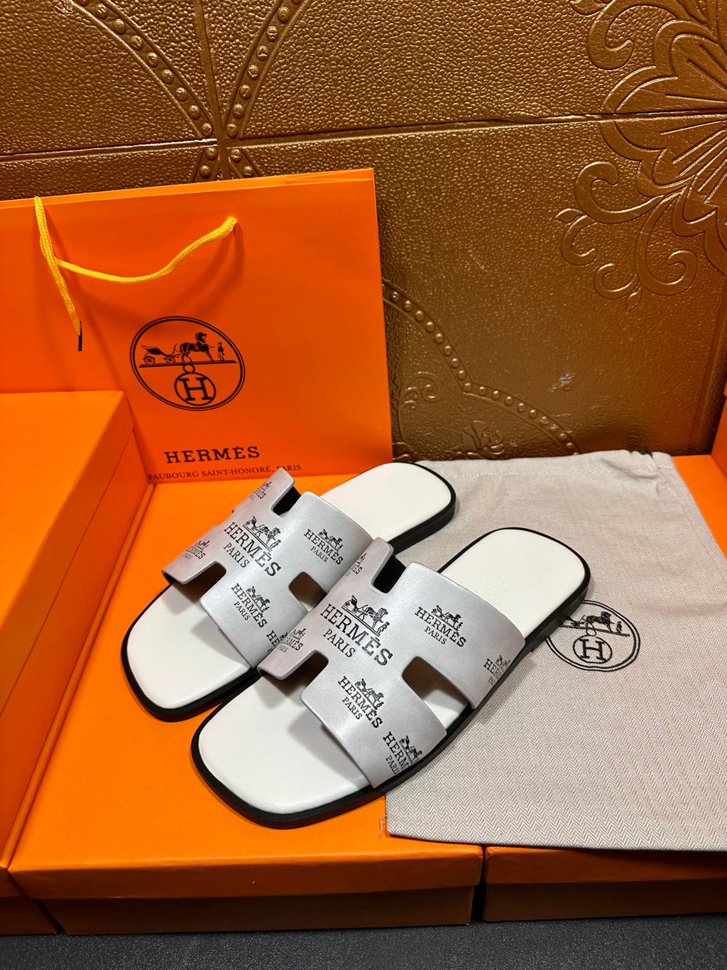 Pair of Hermes white slide sandals with black logo print straps