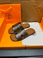 Dark gray slide sandals with two wide logo straps and cushioned footbed