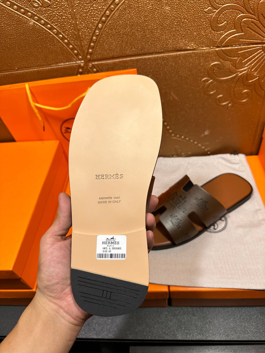 Dark gray slide sandal outsole view with brand text and "Made in Italy"