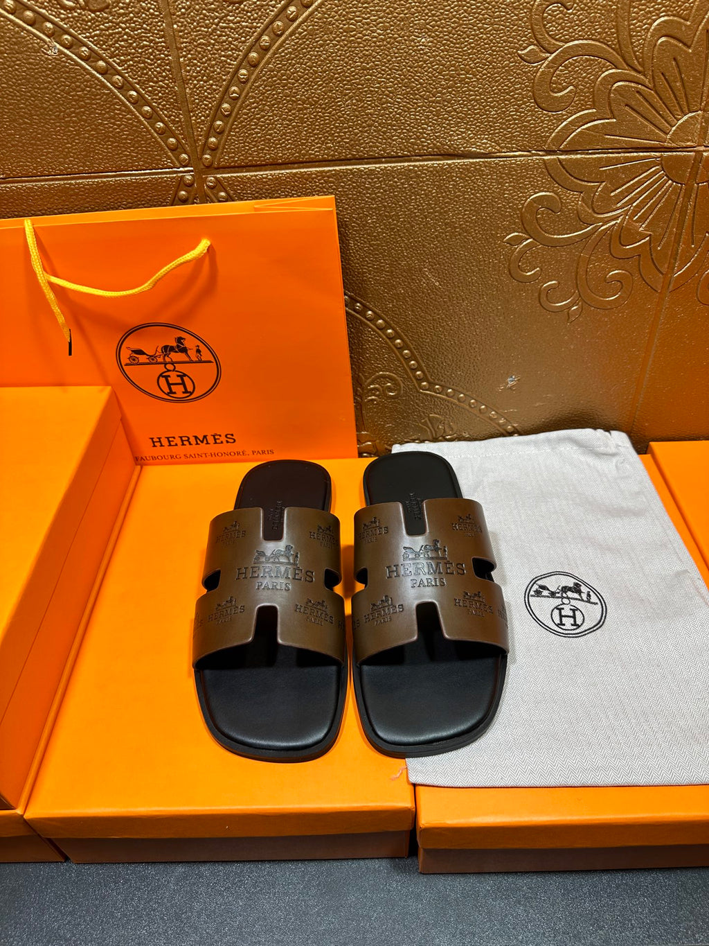 Hermes slide sandals with dark brown logo-print straps and black soles