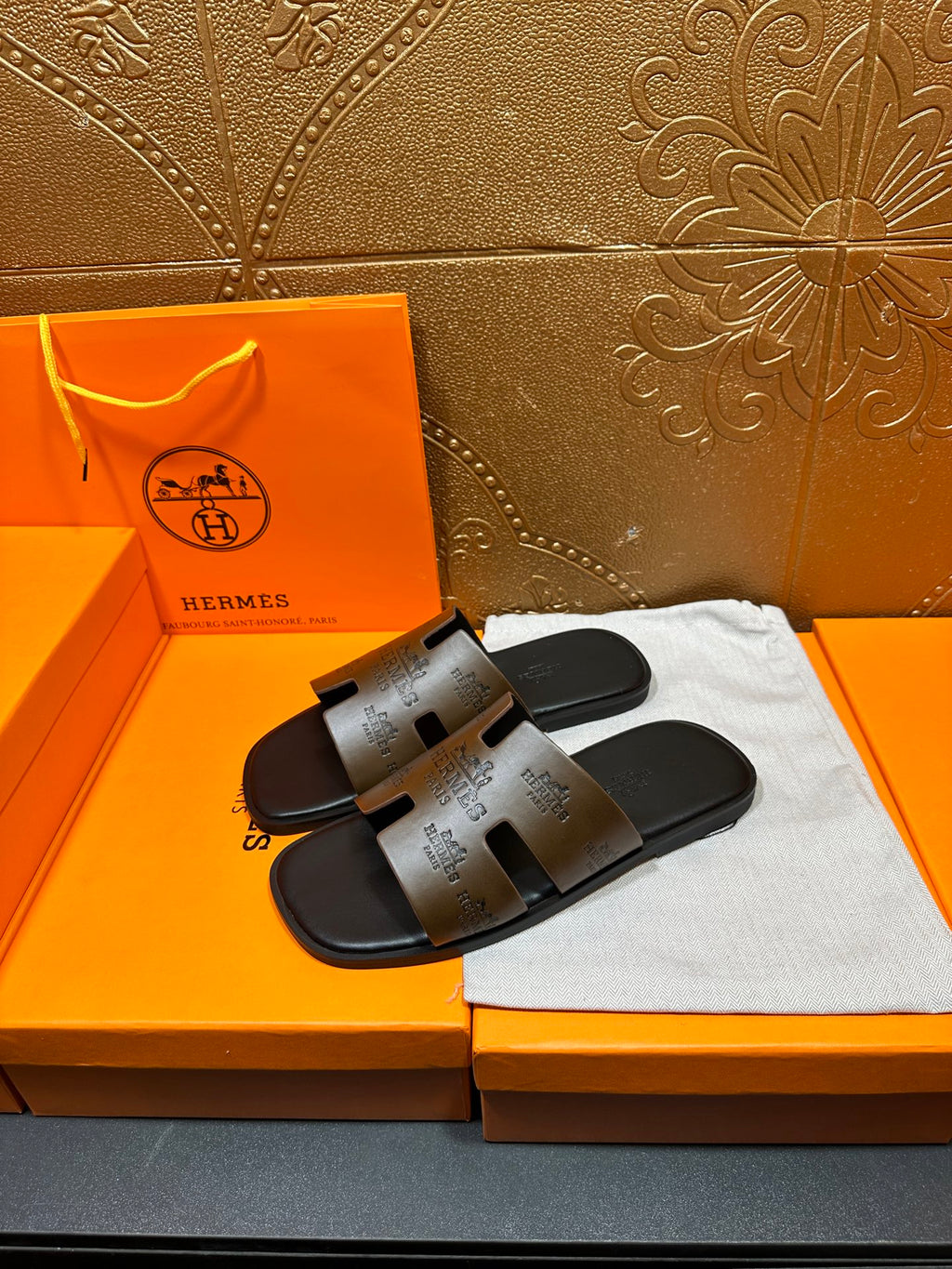 Hermes slide sandals with dark brown printed footbeds and black rubber soles