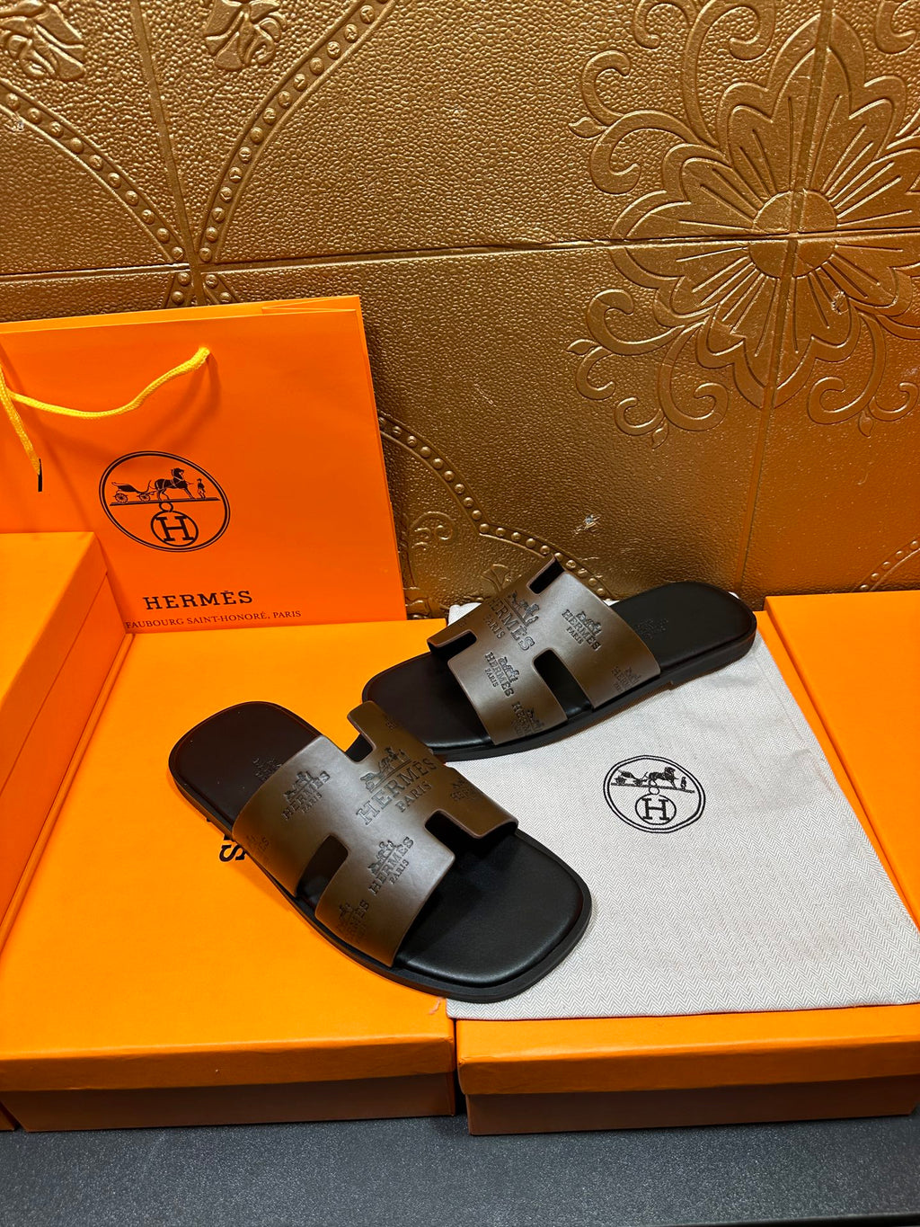 Hermes slide sandals, angled view of dark brown leather-style straps