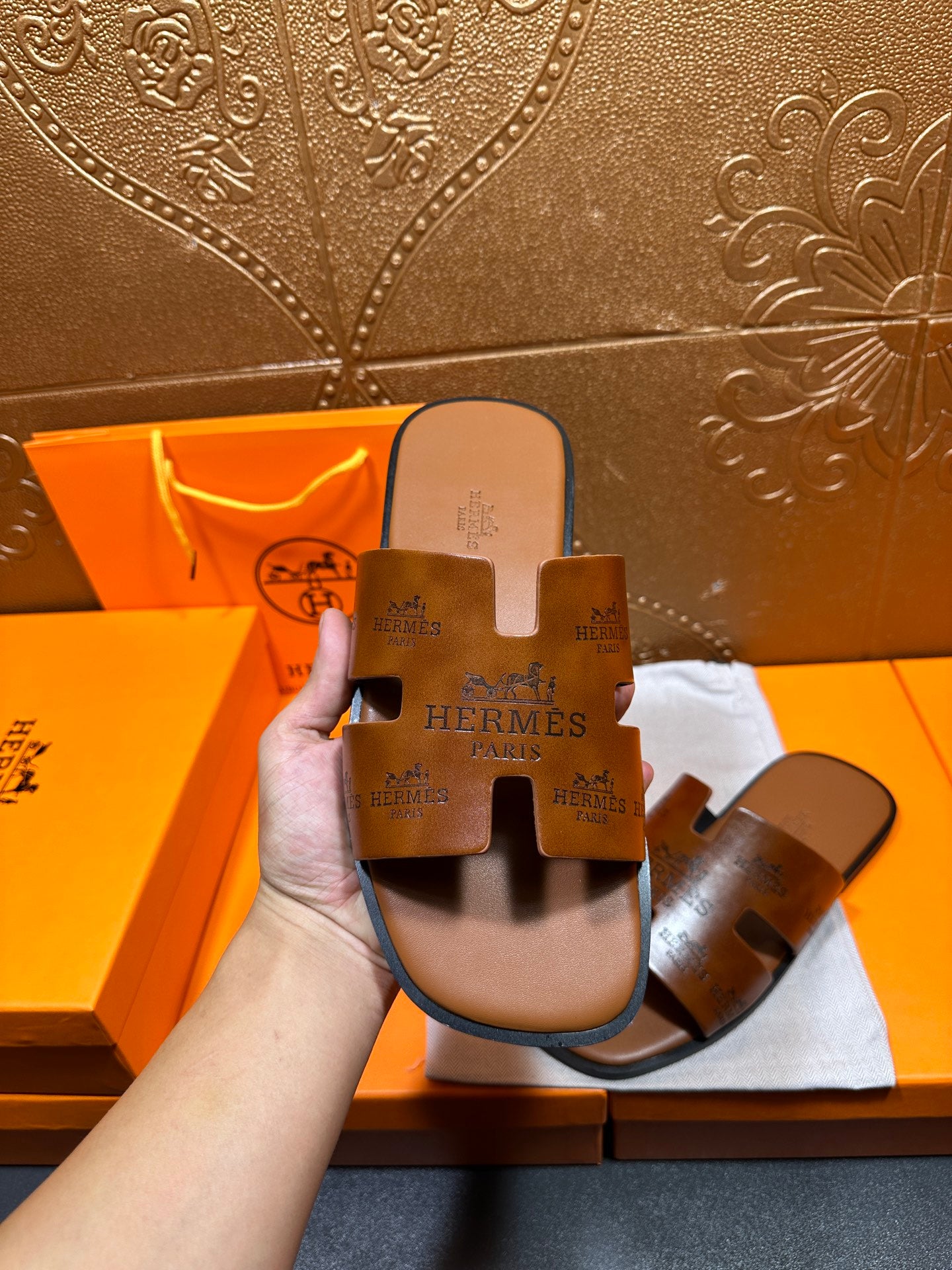 Hermes leather slide sandals held up, dark brown footbed with wide straps