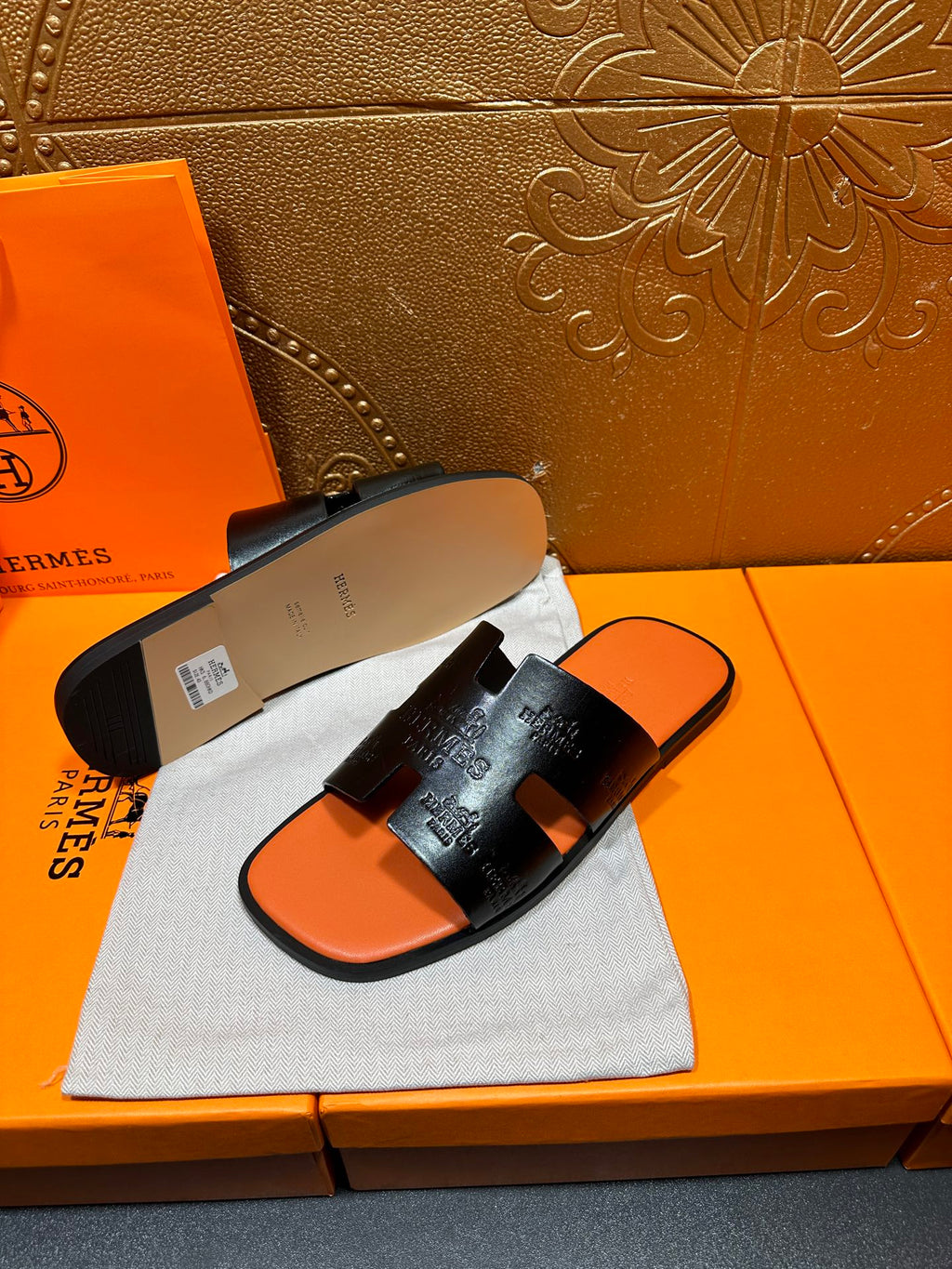 Hermes slide sandals with beige outsole and orange footbed, pair