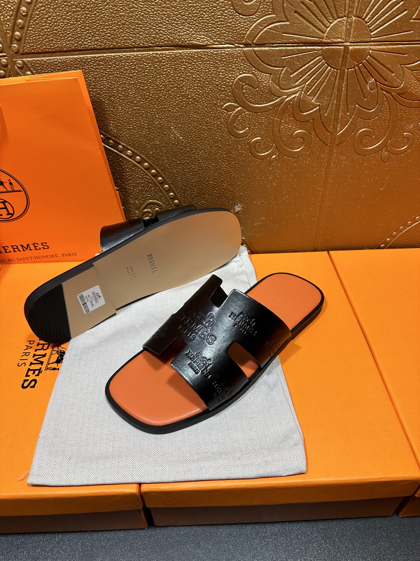 Hermes slide sandals with beige outsole and orange footbed, pair