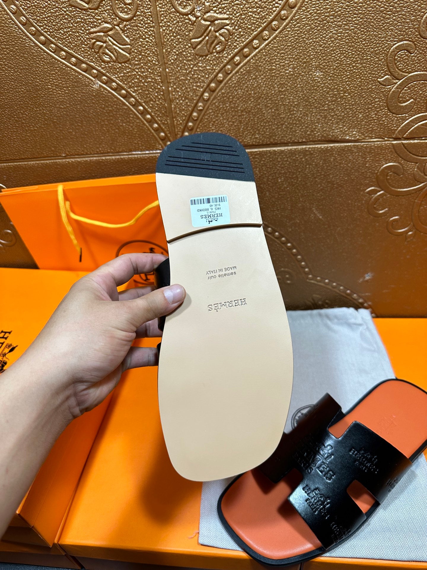 Hermes slide sandal outsole close-up, beige sole with label