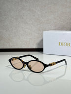 Black oval sunglasses with gold hinge logo and light brown lenses