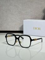 Dior sunglasses with black frame and light amber lenses, gold bar detail