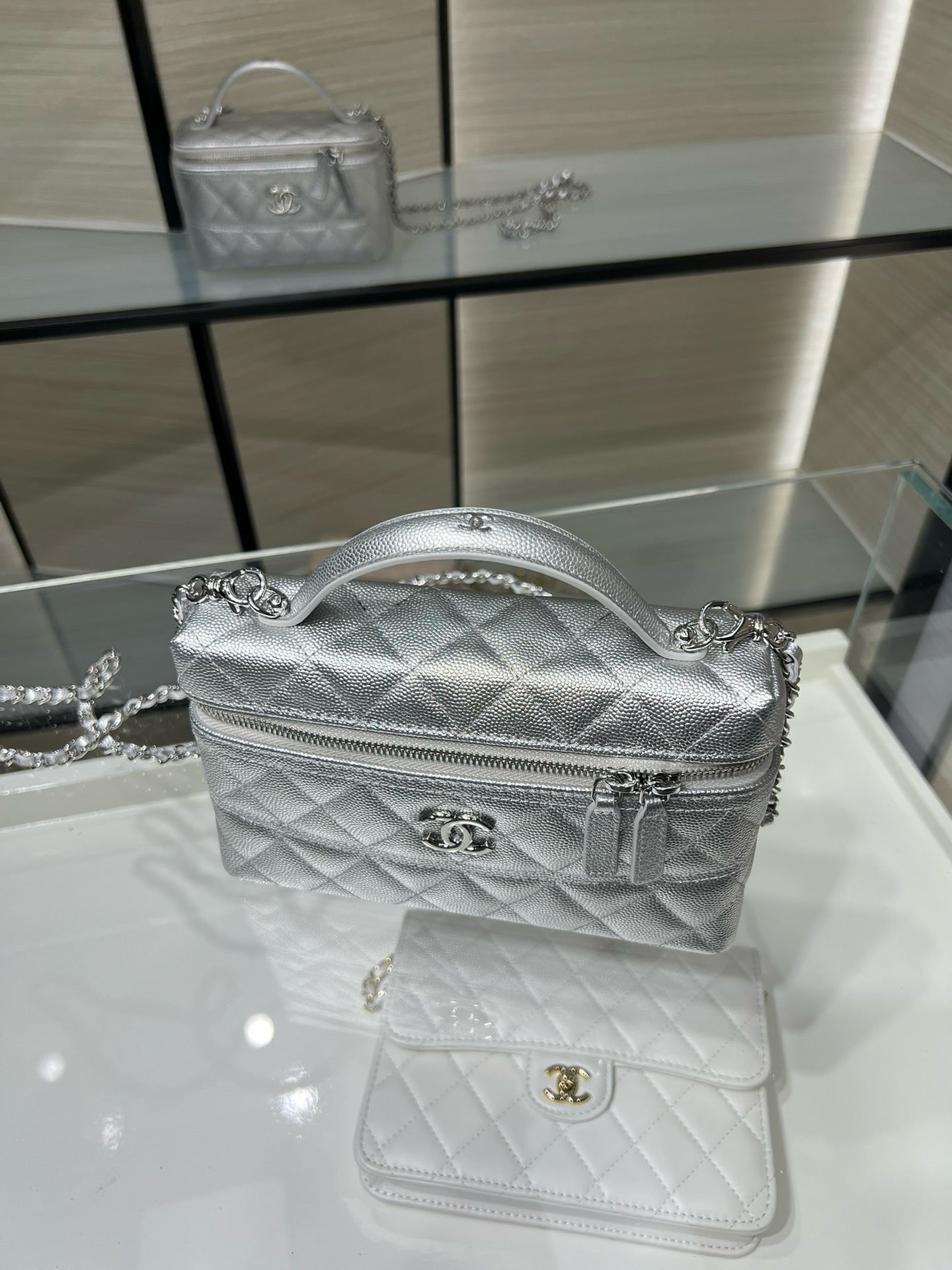 Chanel quilted mini shoulder bag in silver-tone with top handle, chain strap and logo