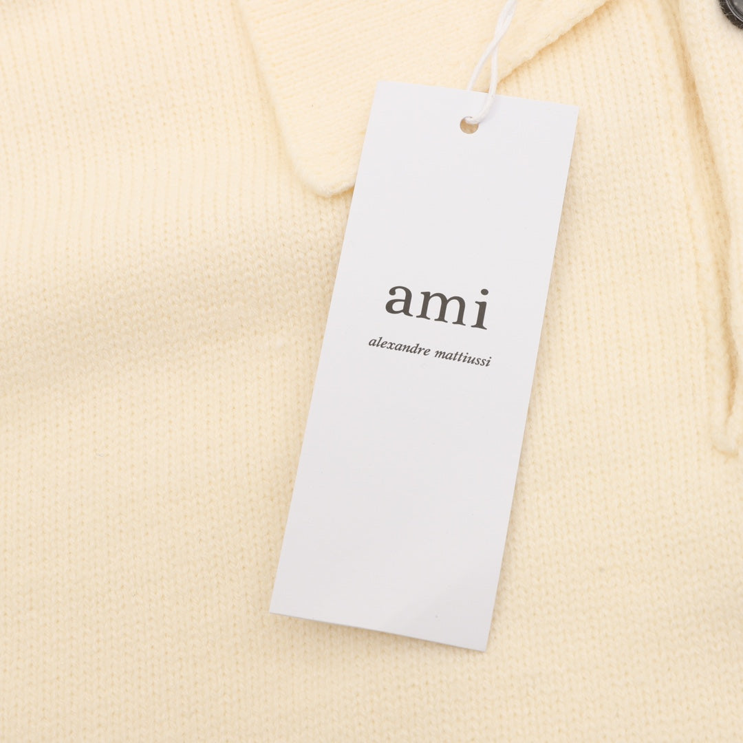 Amiri knit sweater neckline tag with 'ami' logo, cream polo knit