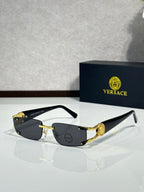 Gold-tone sunglasses with dark tinted lenses and black arms