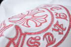 Red embroidered floral crest detail on white T-shirt