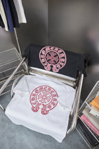 Pair of T-shirts: white and black with matching red crest logos