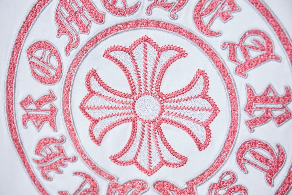 Red and gray embroidered crest logo on white T-shirt