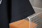 Dark navy T-shirt hem and side seam detail, with no visible additional graphics.