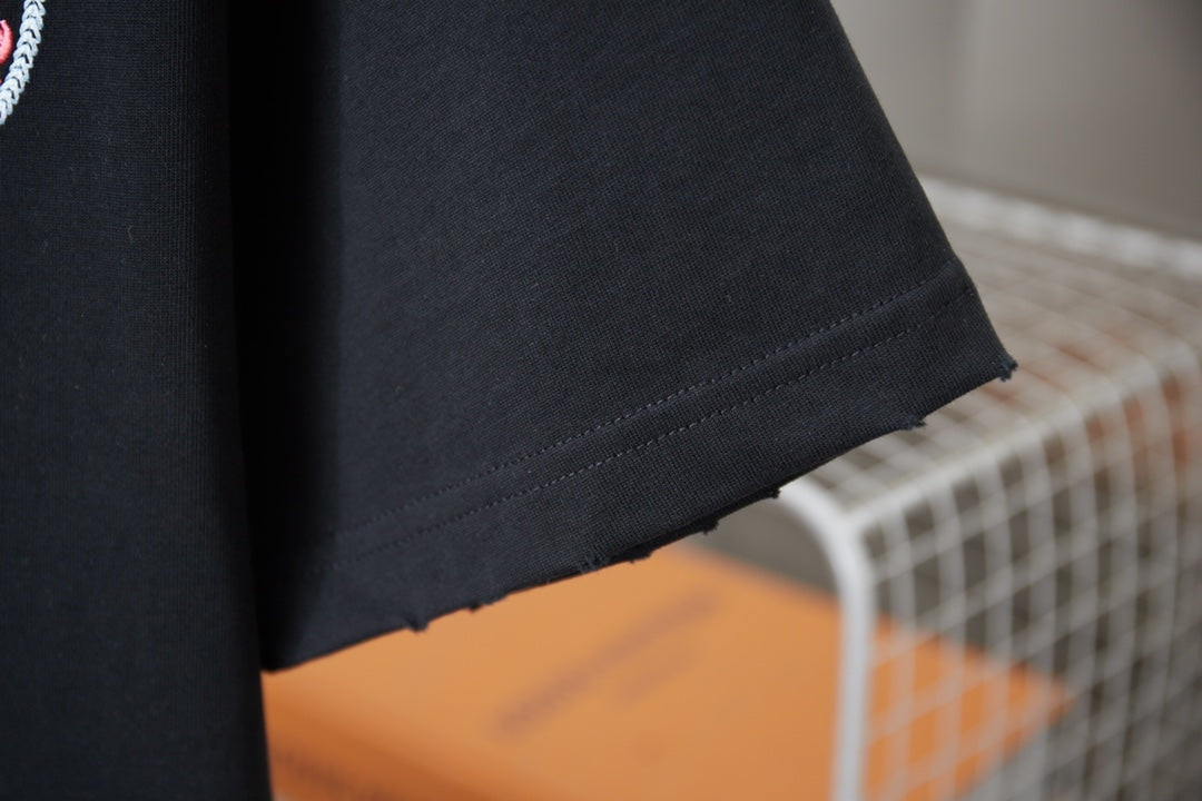 Dark navy T-shirt hem and side seam detail, with no visible additional graphics.