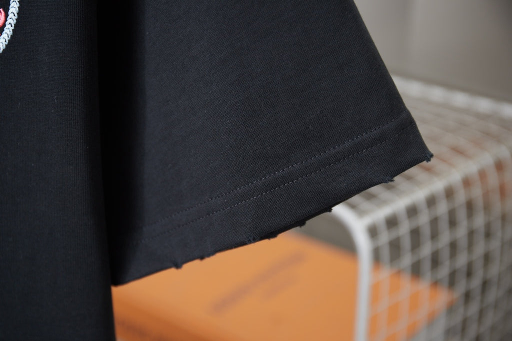 Black T-shirt hem with clean stitched edge and side seam