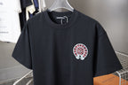Dark navy crewneck T-shirt with small chest embroidered-style circular pink logo.