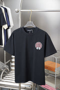 Short-sleeve T-shirt in dark navy with small chest graphic in pink and white.