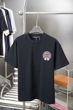 Black short-sleeve T-shirt with small red-and-white circular chest graphic