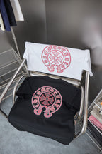 Folded white and black T-shirts with red circular logo graphic
