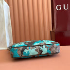 Mini bag end view with teal camo GG fabric and leather top trim