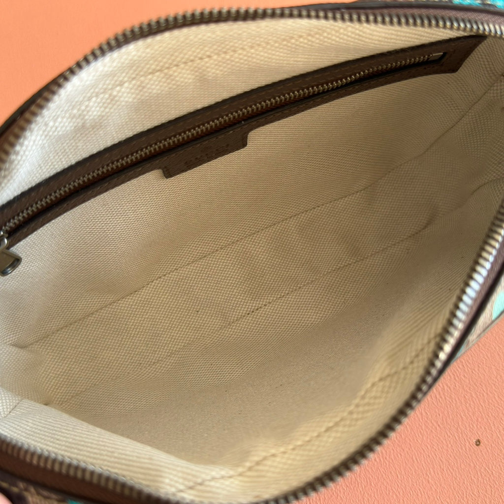 Interior of zipped mini crossbody bag with beige fabric lining