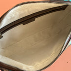 Interior of zipped mini crossbody bag with beige fabric lining