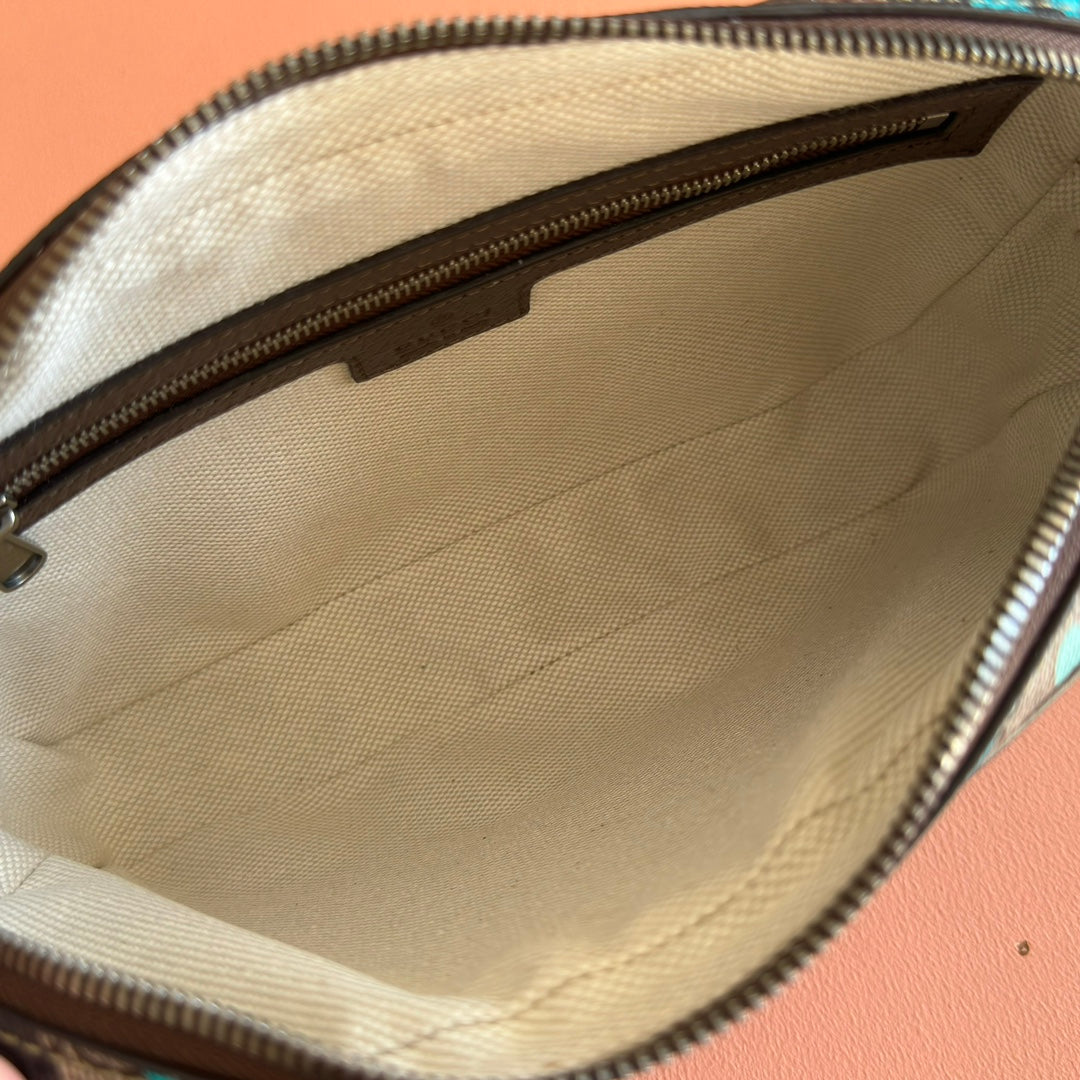 Interior of zipped mini crossbody bag with beige fabric lining