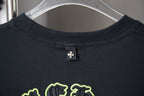 Dark crewneck T-shirt with small chest logo tag at neckline