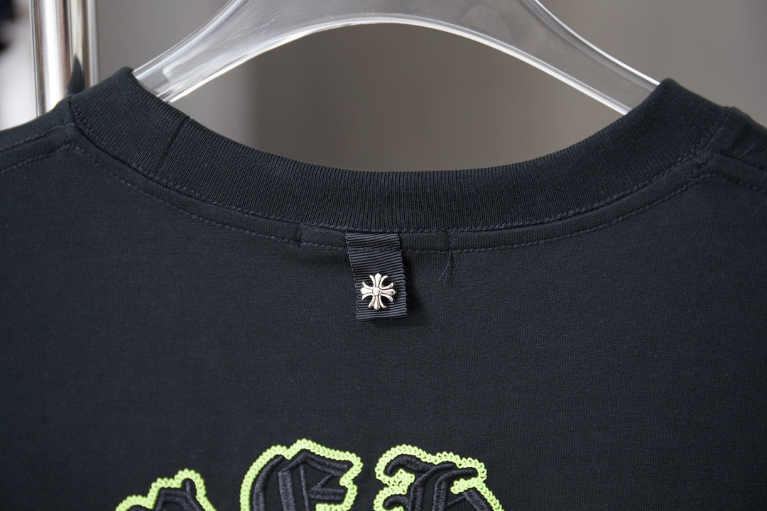 Dark crewneck T-shirt with small chest logo tag at neckline