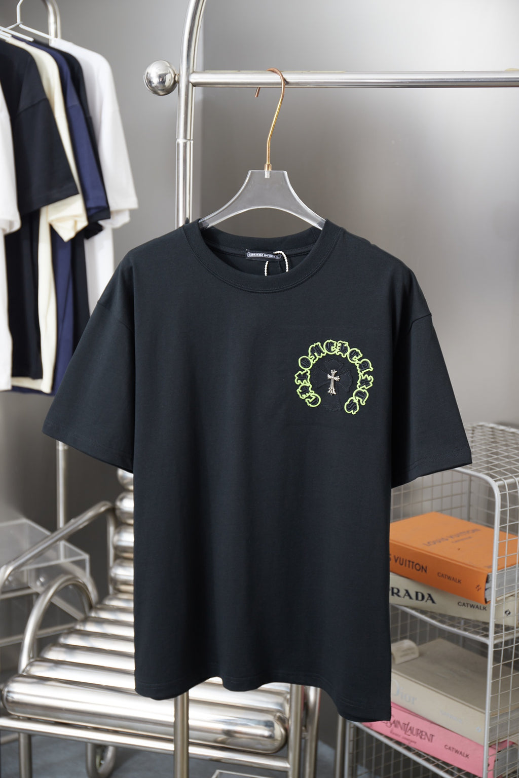 Dark short-sleeve T-shirt with neon green circular graphic and cross print