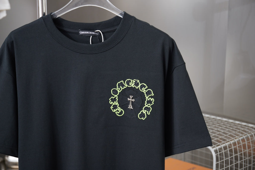 Dark short-sleeve T-shirt with neon green circular crest and cross chest print