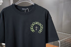 Dark short-sleeve T-shirt with neon green circular crest and cross chest print