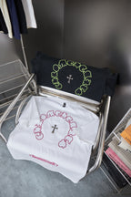 Set of two T-shirts: white and black, each with ring and cross graphic