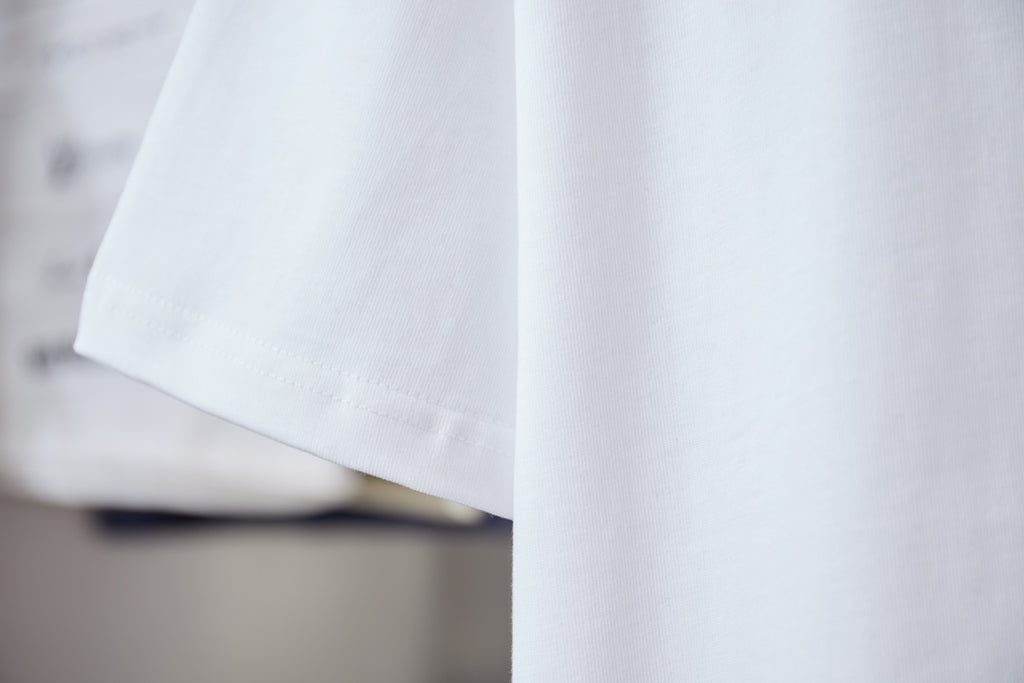 White short-sleeve T-shirt sleeve and hem, embroidered detail near chest